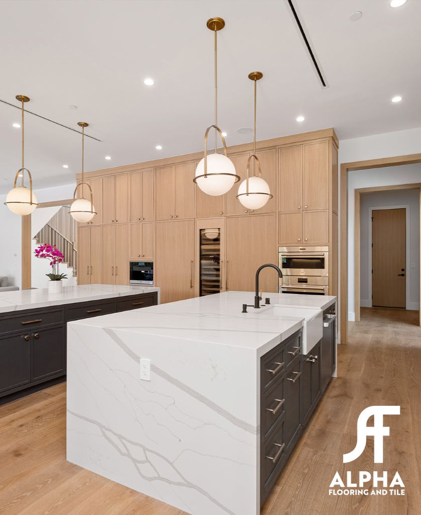 Modern kitchen with marble island and hardwood floor